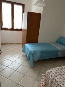 Ένα ή περισσότερα κρεβάτια σε δωμάτιο στο Residenza Sa Conzola