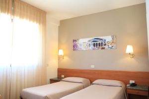 Postel nebo postele na pokoji v ubytování Hotel Sisto V