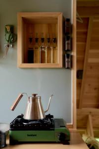 a tea kettle on top of a toaster on a counter at ist - Sado in Sado