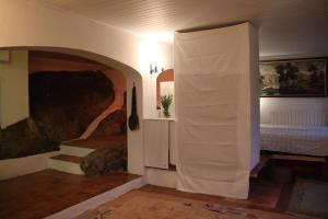 a room with a bed and a painting on the wall at cave house with sea views in Santa Susanna +10 photos