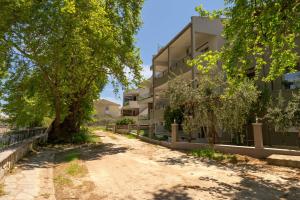 an empty road in front of an apartment building at Kipos Resort in Nea Peramos