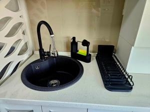 a sink with a faucet on a counter at Modern Studio 4 in Onești