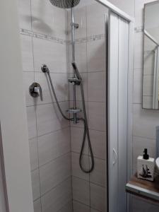 a shower with a shower head in a bathroom at Aligiò in Porto Torres +28 photos