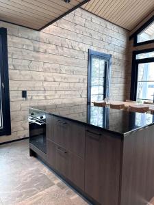 a kitchen with a counter top in a room at Villa Norvahovi - Lake view, sauna and wood interior in Rovaniemi +34 photos
