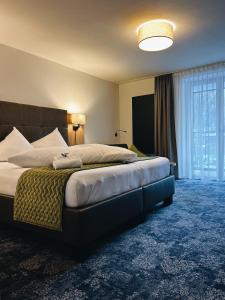 a bedroom with a large bed with a large window at Apart Peppone in Längenfeld