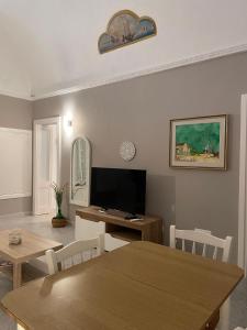 a living room with a table and a television at Casa Moly in Monopoli