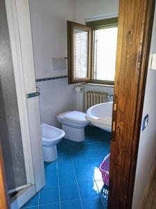 a bathroom with two toilets and a sink at Valle del Tione-prenotazioni singole- in Canonica +33 photos
