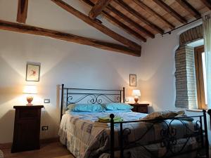 a bedroom with a bed with blue pillows at Valle del Tione-prenotazioni singole- in Canonica