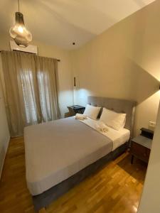 a bedroom with a large white bed and a desk at Elegant and spacious penthouse in Mesochórion +23 photos