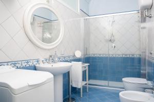 a blue and white bathroom with a sink and a toilet at Villa Alba - Zaffiro in Amalfi +51 photos