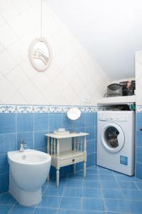 a blue bathroom with a washing machine and a sink at Villa Alba - Rubino in Amalfi