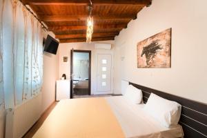 a bedroom with a bed in a room at Kipos Resort in Nea Peramos