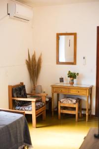 a room with a desk and a chair and a mirror at Miltiadis Apartments in Kokkari