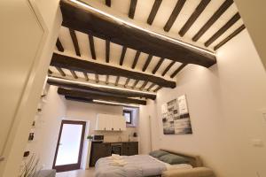 a bedroom with a bed and a ceiling with beams at Suite n12 - Loft incantevole nel cuore di Perugia in Perugia +18 photos