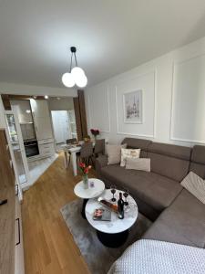 a living room with a couch and a table at Aura Apartment in Berane