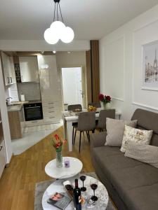 a living room with a couch and a table at Aura Apartment in Berane