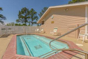 a swimming pool in front of a building at Lake Conroe One-Bedroom Cabin 3 in Willis