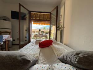 a large bed in a room with a view of a table at La Vacanzella in Ponti Sul Mincio