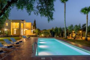 a swimming pool with chairs and a house at Aloni Grove Retreat in Chania +72 photos
