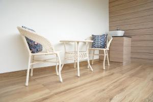 two wicker chairs and a table in a room at ViewandChill in Kolli Hills
