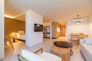 a living room with a couch and a table at Apartamentos Playa Victoria in Cádiz