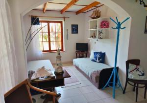 a bedroom with a bed and a desk and a window at Horgony Vendégház in Mezőtúr