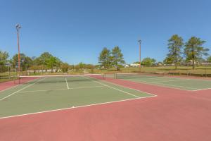 a tennis court with two tennis courts at Lake Conroe Queen Studio Cabin 5 in Willis +6 photos