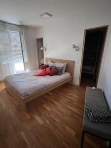 a bedroom with a bed with red pillows on it at Chambre d'hôte-abc in Reims
