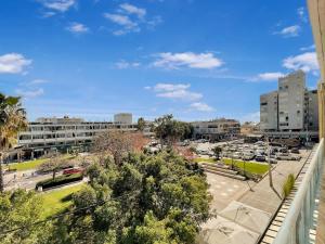 a view from a balcony of a parking lot at Elegant Beachside Apartment in Herzliya B