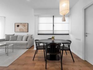 a living room with a table and a couch at Ritzside Marina Stay in Herzliya B