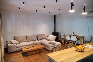 a living room with a couch and a table at Pantsο villa in Nafpaktos