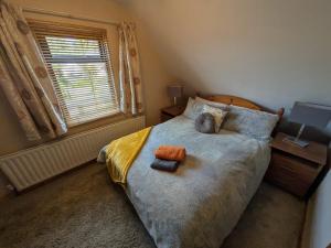 a bedroom with a large bed and a window at The Loft at Rowantree Cottage in Dromara