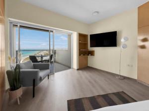a living room with a couch and a view of the ocean at The Sharon Secret Pearl in Herzliya B