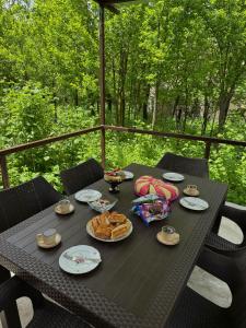 a black table with plates of food on it at Дом на улице Овсепяна 7 in Dilijan