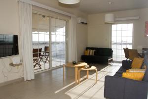 a living room with a couch and a table at Kalamata 360 View in Kalamata
