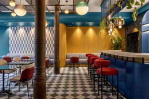 a restaurant with red stools and a bar at LOCANDA SANTAMARINA Dimora di Charme in Palermo