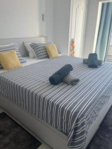 a large bed with blue and white sheets and pillows at Le Grand Bleu in Nice