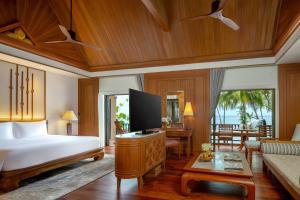 a bedroom with a bed and a living room at Anantara Hua Hin Resort in Hua Hin