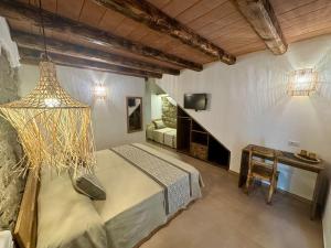 a bedroom with a bed and a chandelier at Il Busciolotto in Santa Teresa Gallura