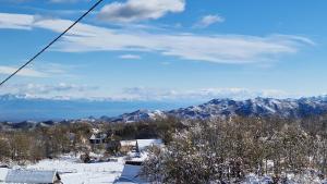 a view of a snowy mountain with mountains in the background at Mountain Village House in Cetinje