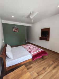 a bedroom with a bed and a flat screen tv at Moon Valley, kanthalloor in Kanthalloor +24 photos