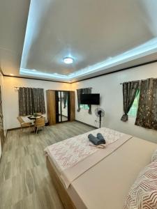a bedroom with a large bed and a living room at Buenacosa Resort in Panglao Island +24 photos