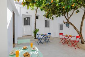 a patio with a table and chairs and a tree at Cleopatra's Backyard in Rhodes Town