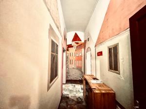 an empty hallway of a building with a wooden table at Oasis Valley in Karlovy Vary