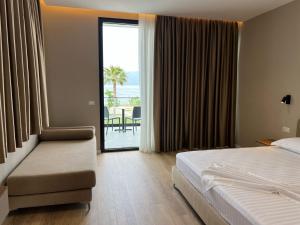 a hotel room with a bed and a view of the ocean at Villa Blu in Vlorë