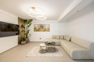 a white living room with a couch and a table at Villa Lavea in Trogir