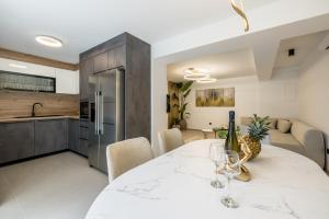 a kitchen and dining room with a white marble table at Villa Lavea in Trogir