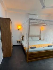 a bedroom with a bunk bed in a room at Casa Lashmika in Hikkaduwa