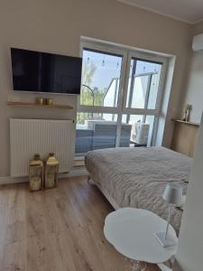 Giường trong phòng chung tại Blue Sky Apartment & SPA Dziwnów +20 ảnh