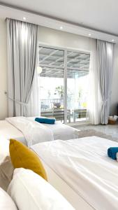 a group of four beds in a room at Al Rajhi House in Al Maşna‘ah